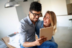 Couple lauging looking at ipad